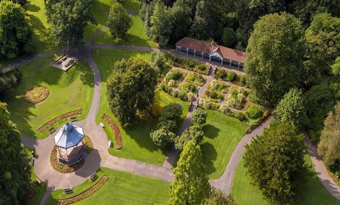 An overhead shot of the grounds of the park featuring the bandstand and the long shelter.